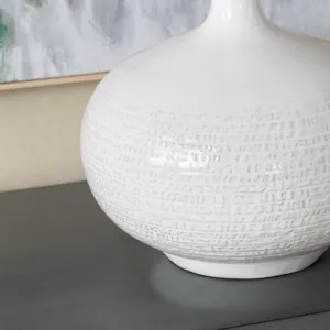 Set Of 2 White Ceramic Table Lamps With Etched Detailing And Drum Shades.