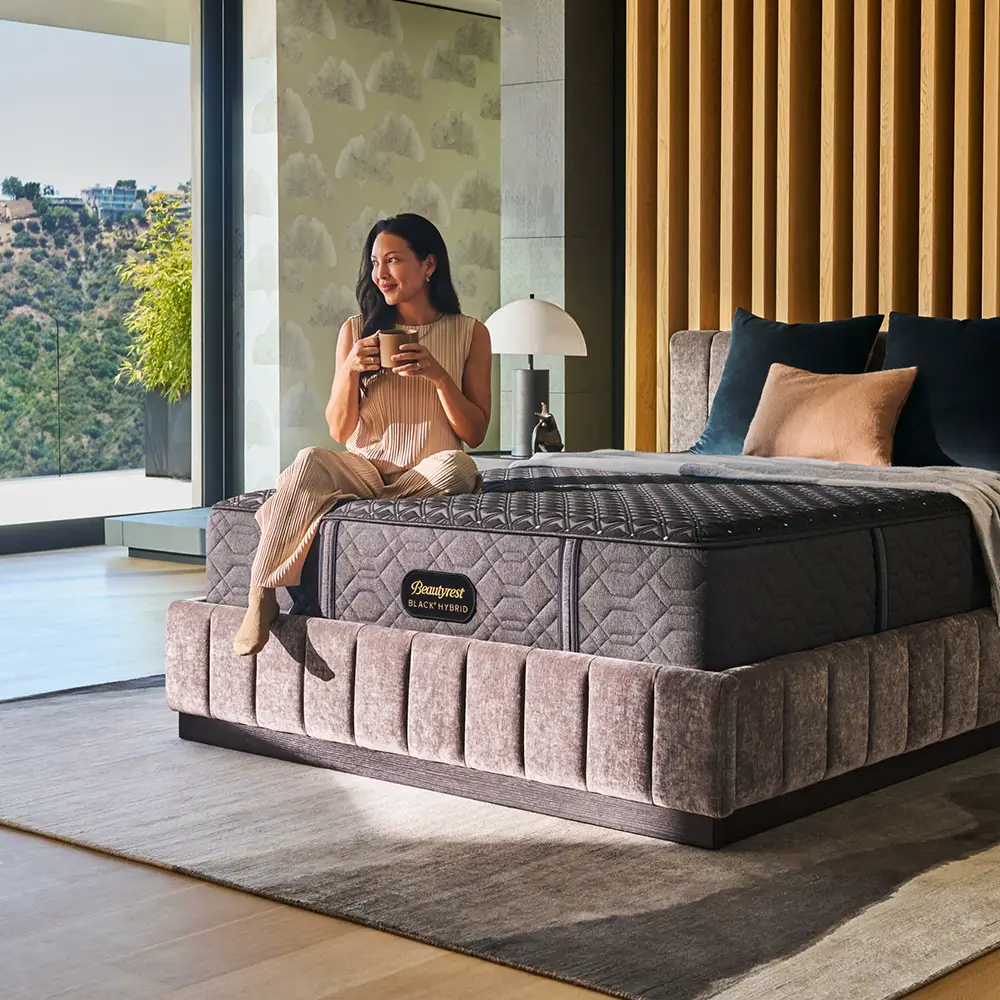 Woman drinking coffee on a Beautyrest mattress