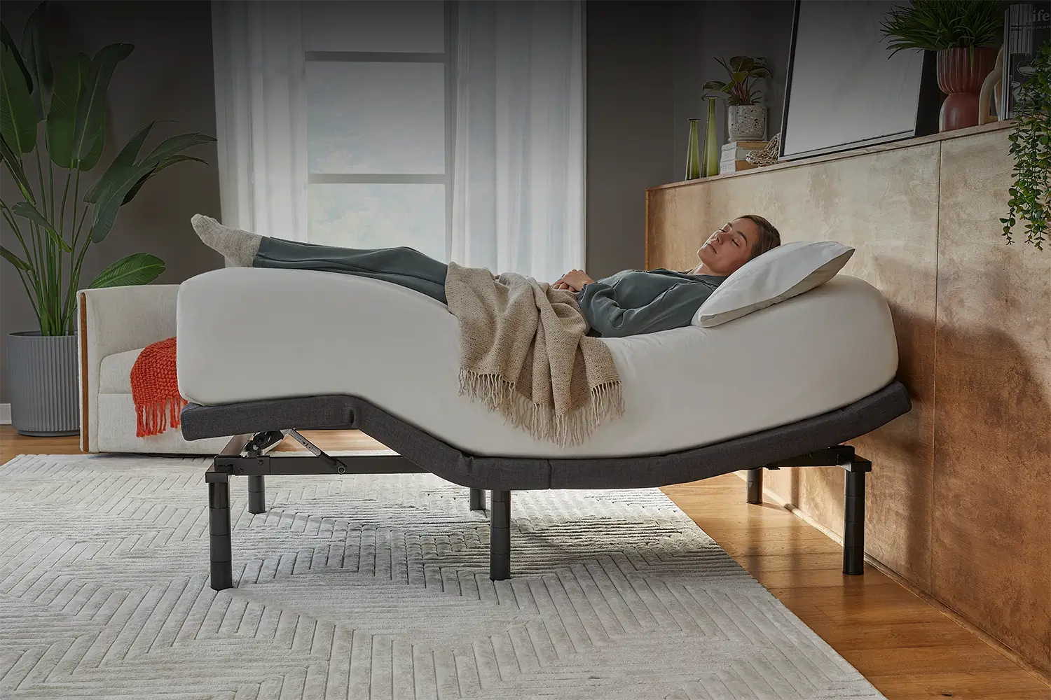 Woman lying on an adjustable mattress
