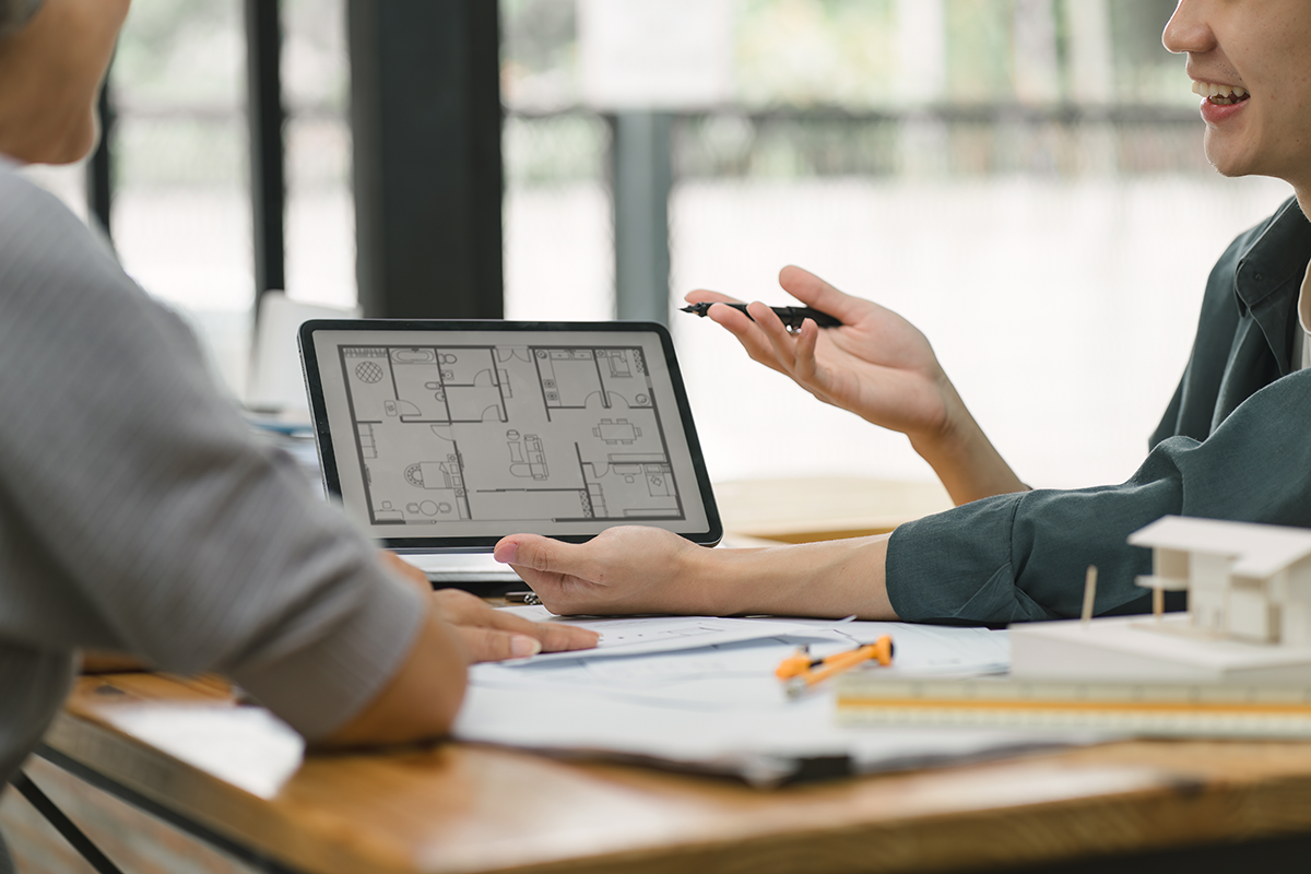 Designer and client discussing a floor plan