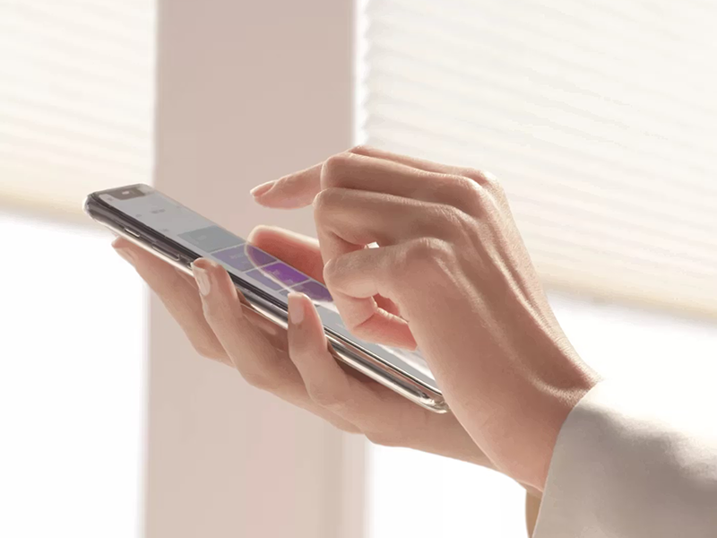 Motorized Hunter Douglas shades being controlled by a smartphone