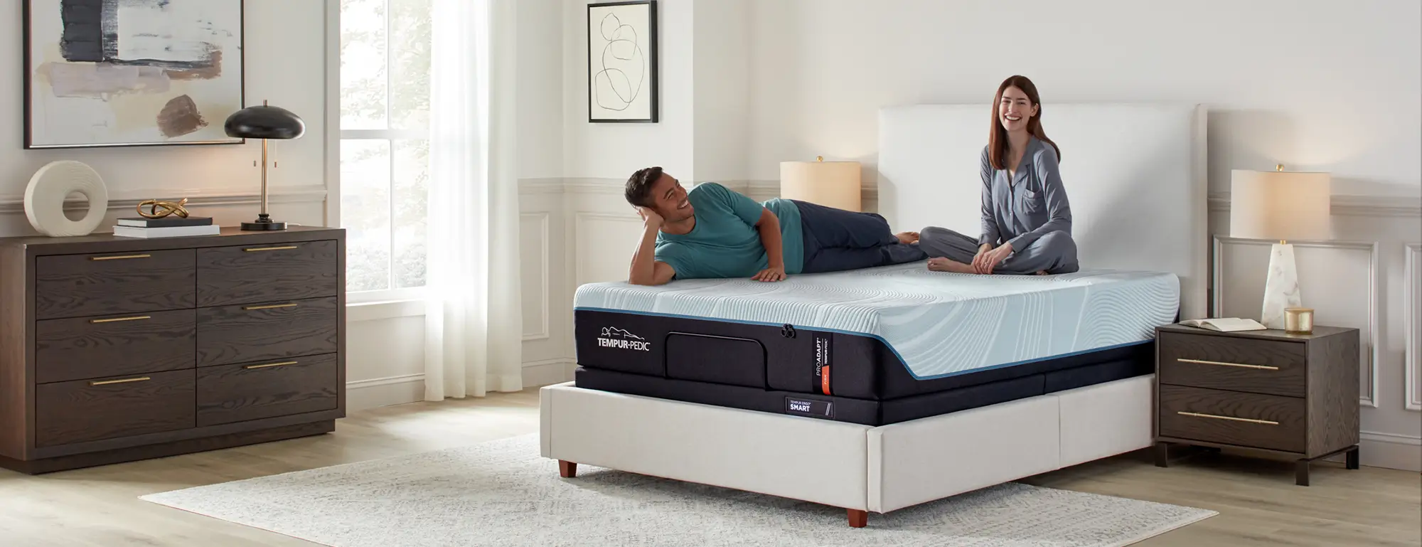 Man and woman relaxing in a bedroom with a Tempur-Pedic mattress