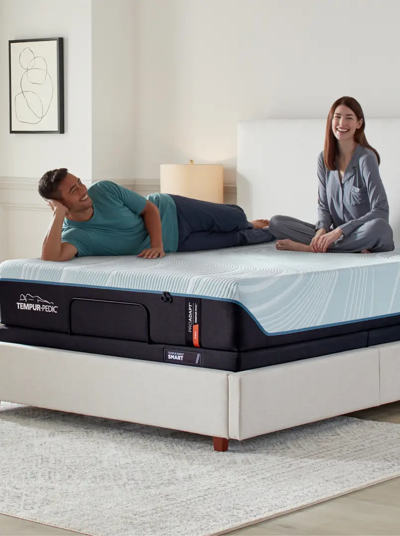 Man and woman relaxing in a bedroom with a Tempur-Pedic mattress