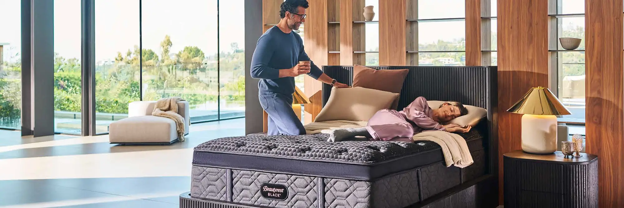 Man and woman relaxing in a bedroom with a Beautyrest Black mattress