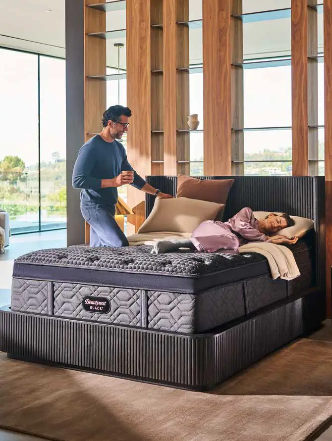 Man and woman relaxing in a bedroom with a Beautyrest Black mattress