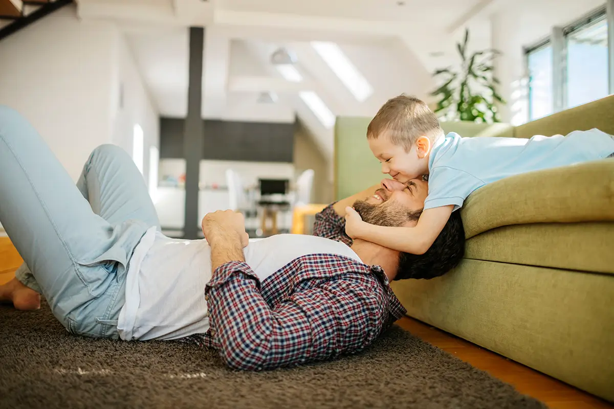 Happy father and son in living room