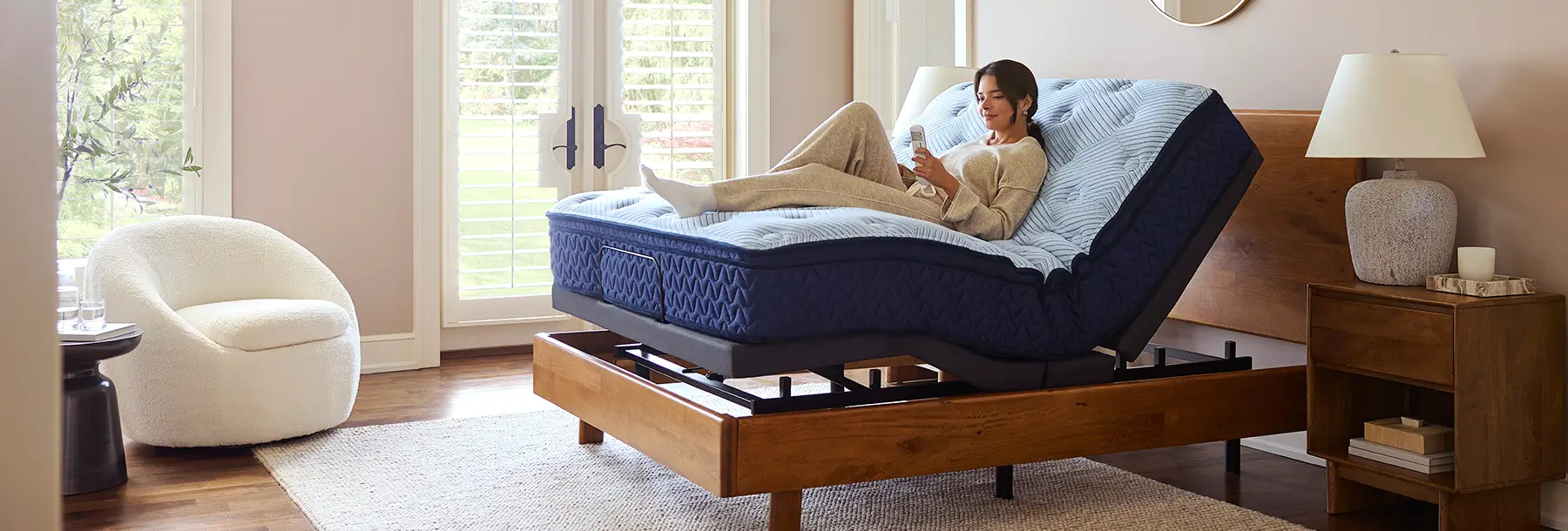 Woman relaxing on an adjustable mattress base in a bedroom