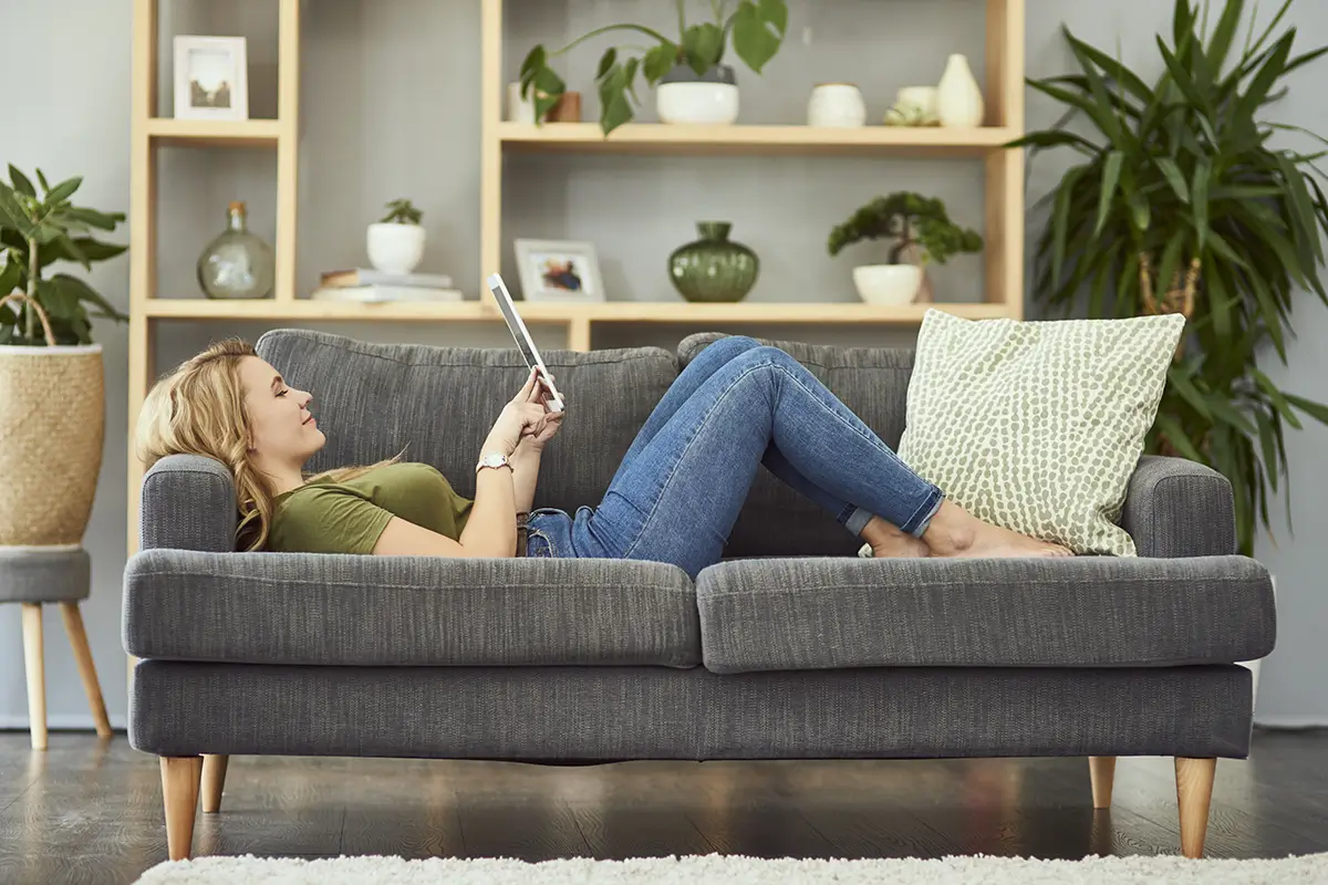 Woman on sofa using computer