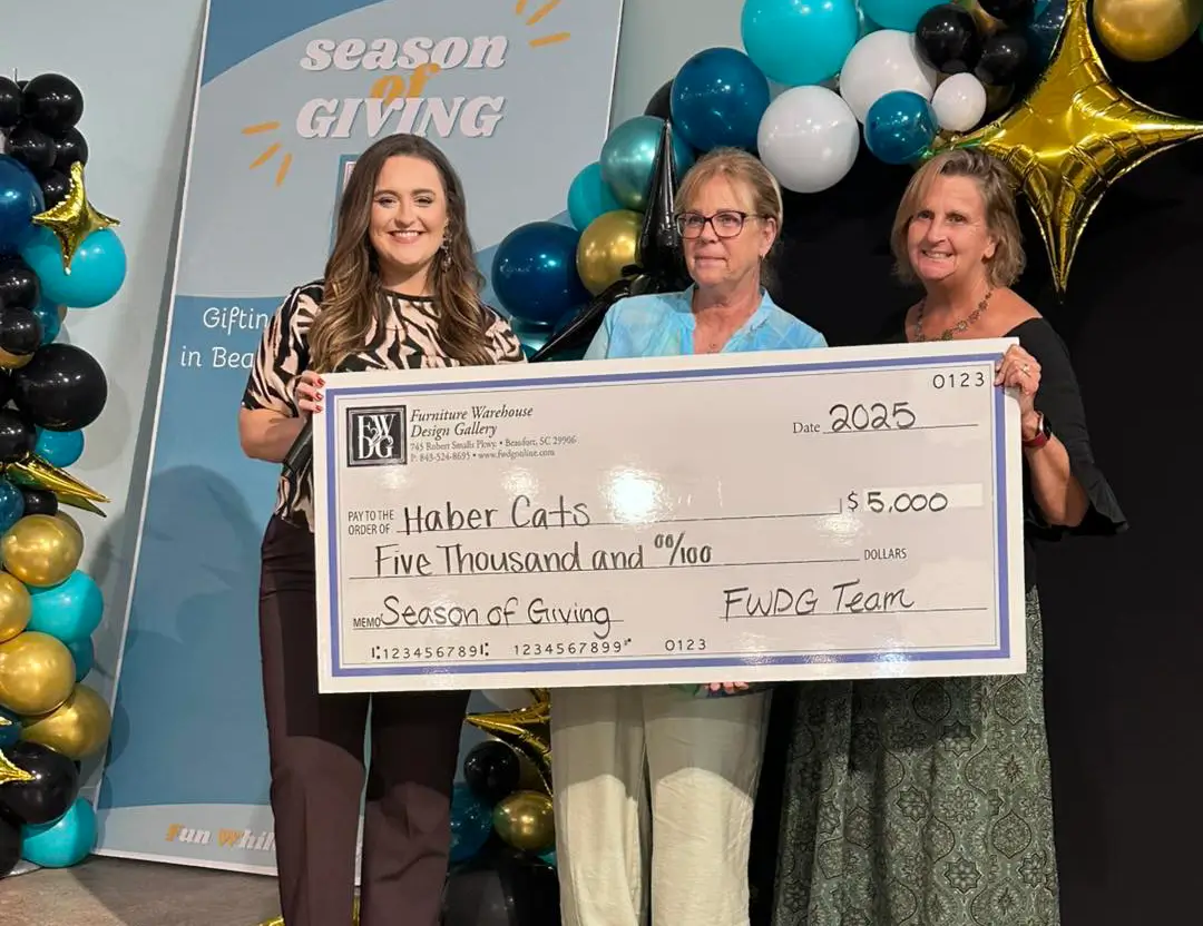 Photo from Season of Giving event where check is given to Haber Cats