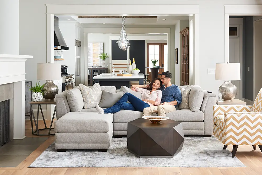 Couple in upholstered furniture in a living room