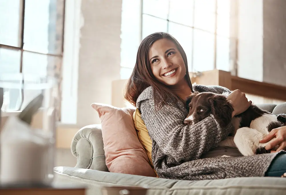 Woman with a dog on the couch