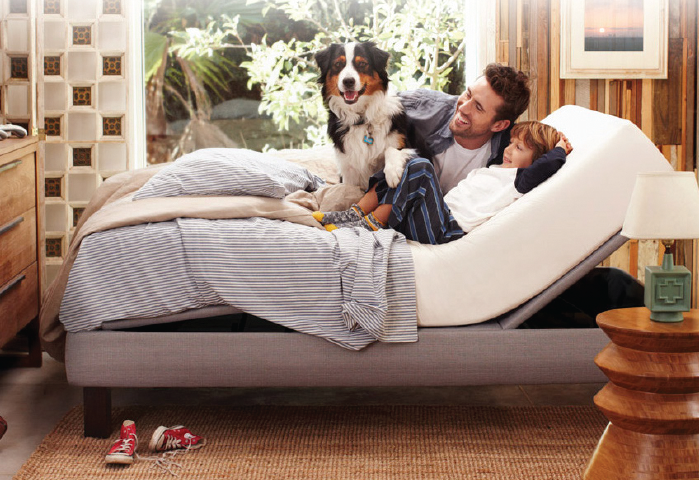 Man with dog on adjustable bed
