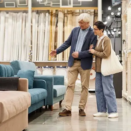 A couple browsing sofas together