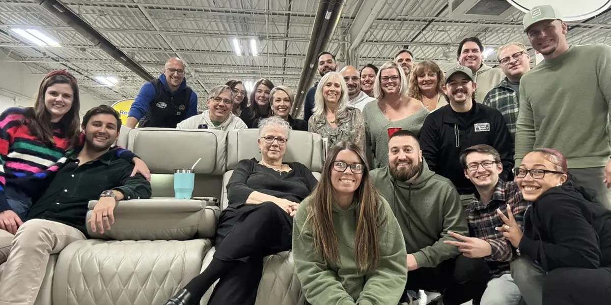 NEFD team members gathered on a showroom sectional