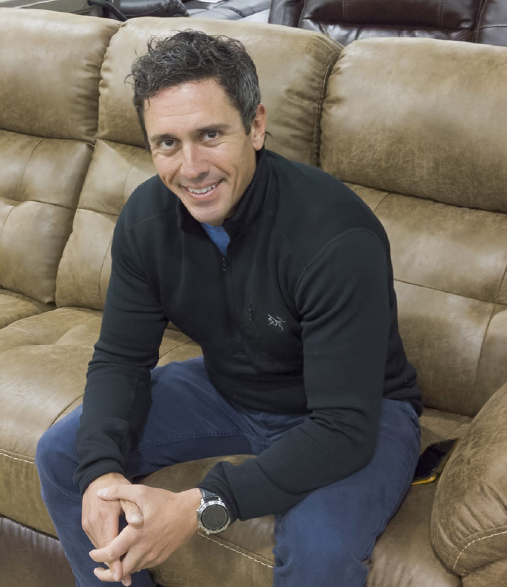 NEFD founder Alex Nemet seated on a leather sofa