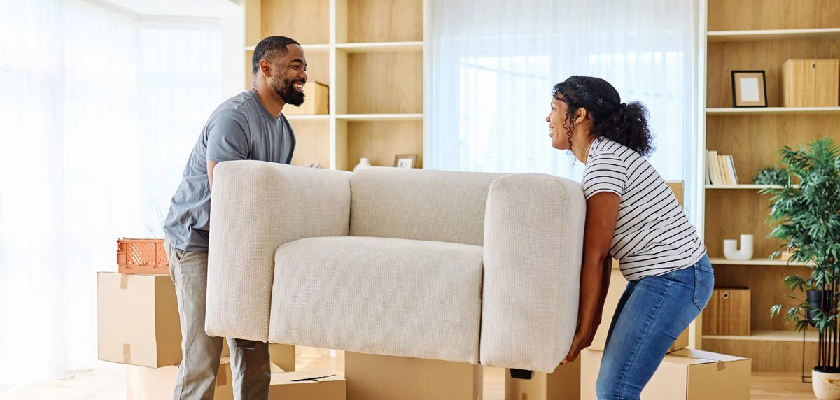 Couple carrying a sofa