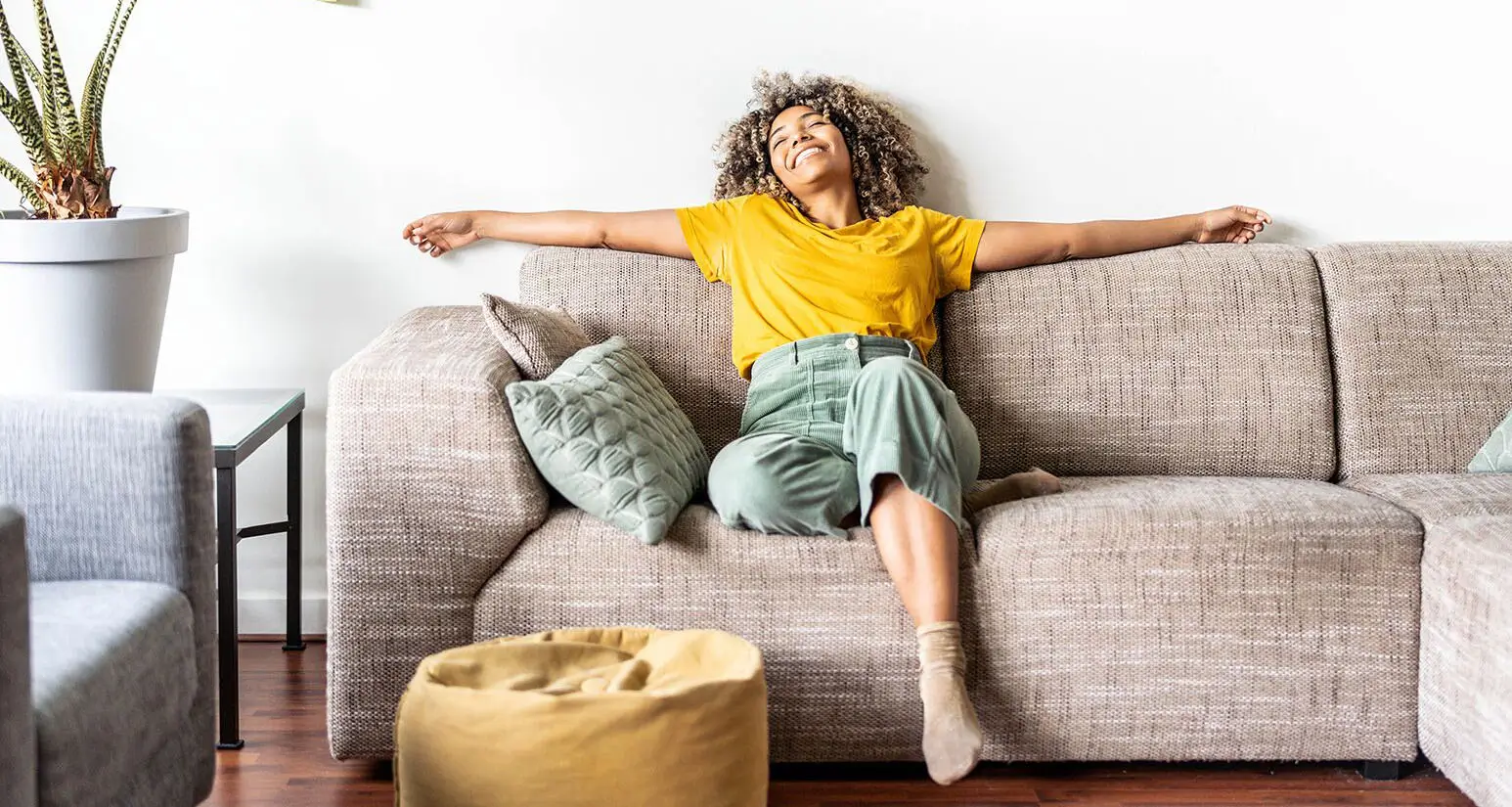 A woman relaxing on a sofa in her living room