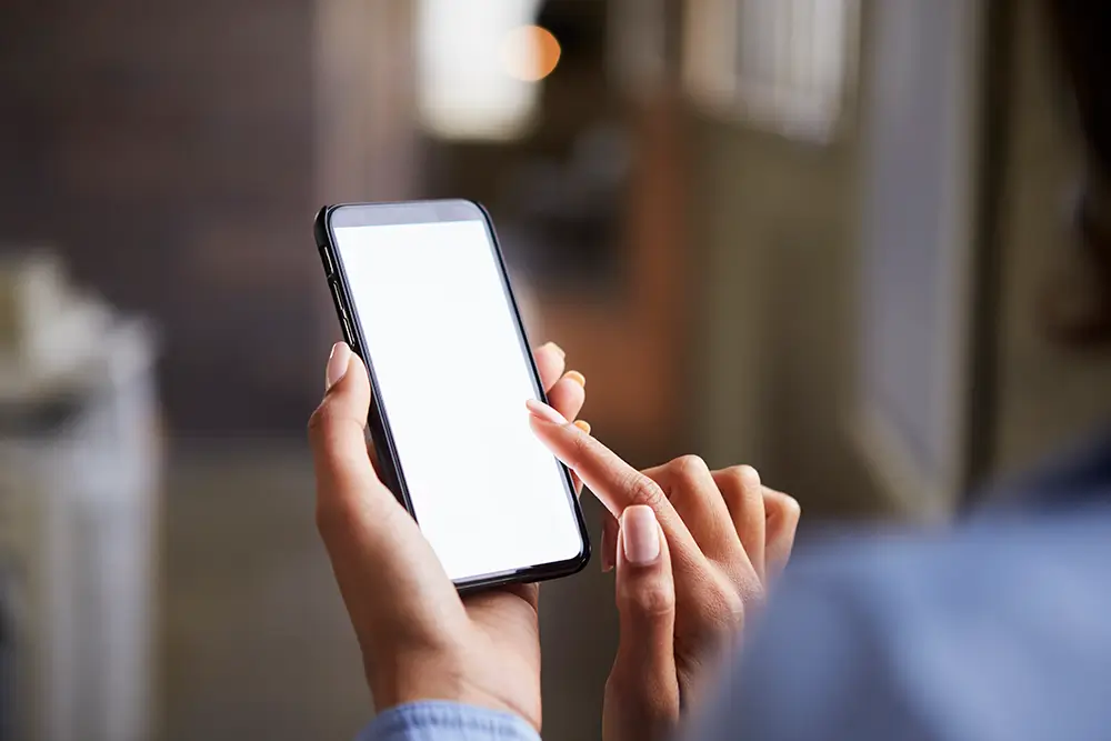Close-up of woman using a smartphone to check delivery status