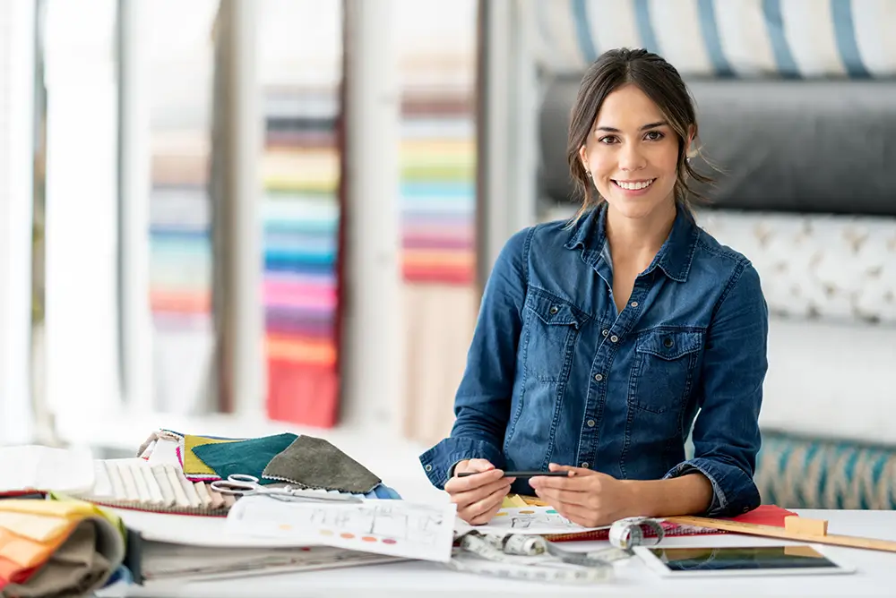 A designer smiling while working with swatches