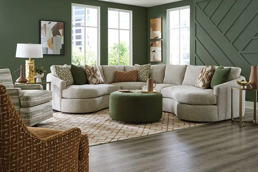 Living room with a light sectional, accent chairs and an ottoman