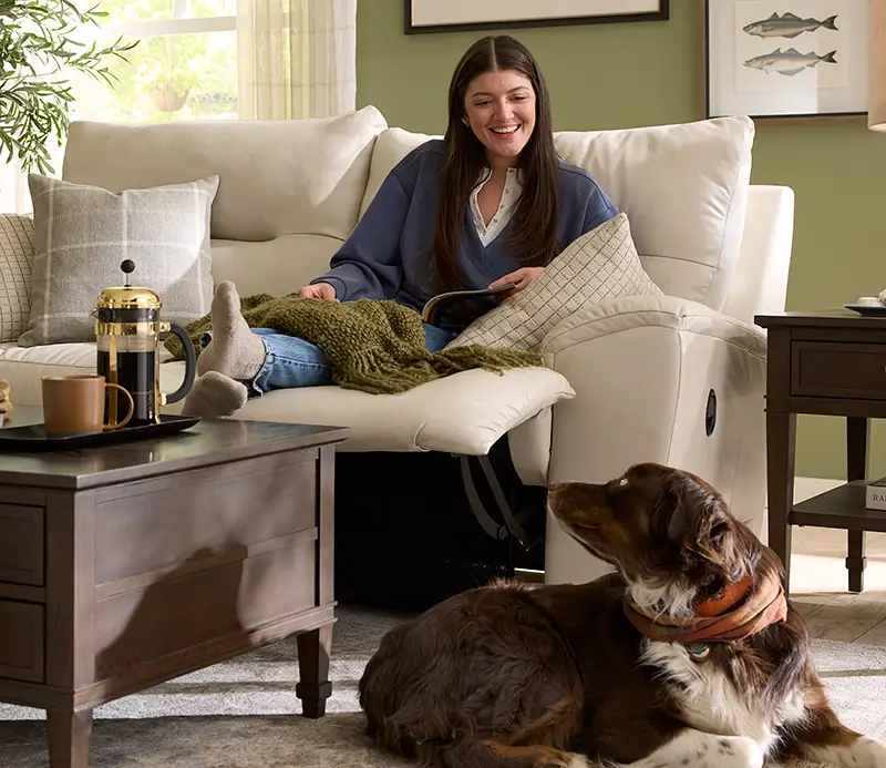 Woman relaxing in a La-Z-Boy recliner with her dog