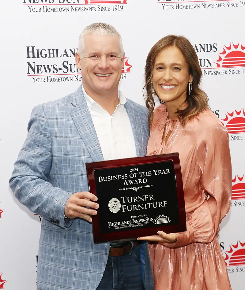 Travis and Wendy Turner holding the 2024 Business of the Year award